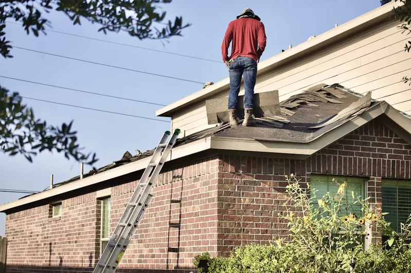 Professional roofer working on a residential roof in Brownlee Woods